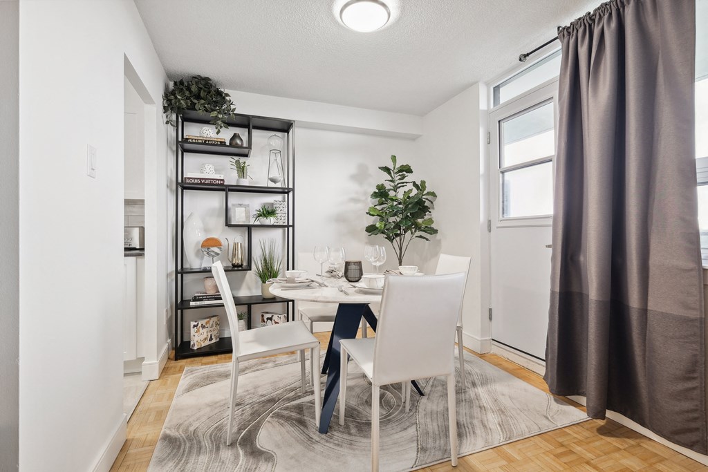 an image of a dining room with a table and chairs