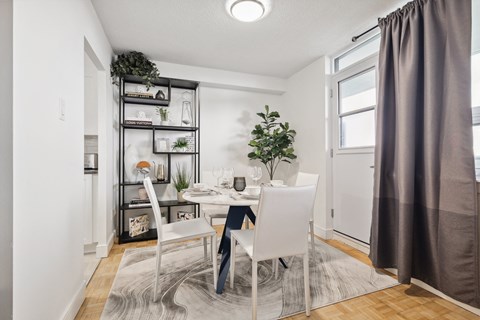 an image of a dining room with a table and chairs