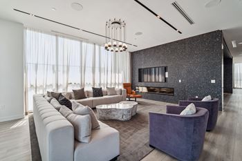 a large living room with couches and chairs and a fireplace