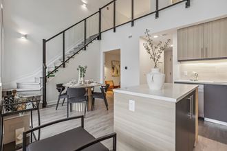 a kitchen with a dining area and a staircase in a house