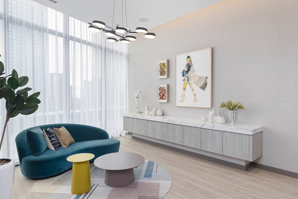 a living room with a blue couch and a white table