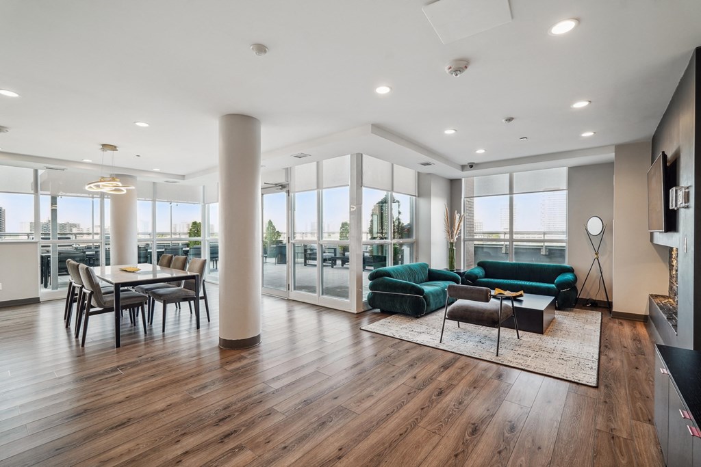 a living room with a green couch and a dining room table