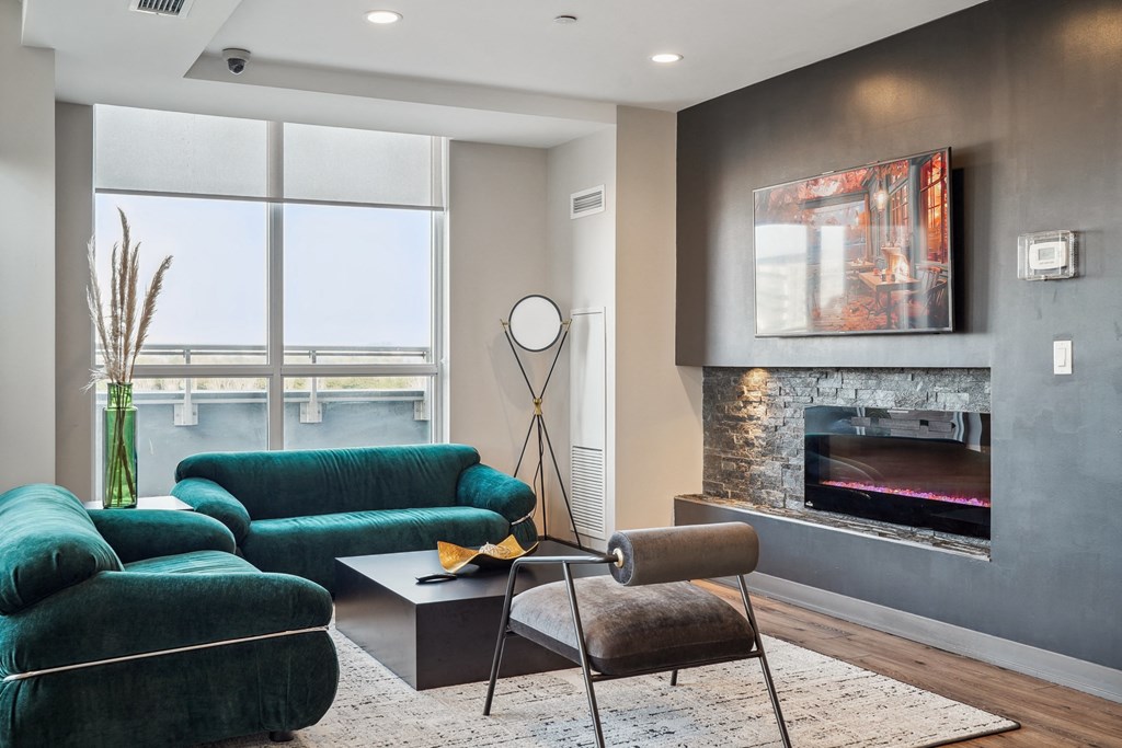 a living room with green couches and a fireplace