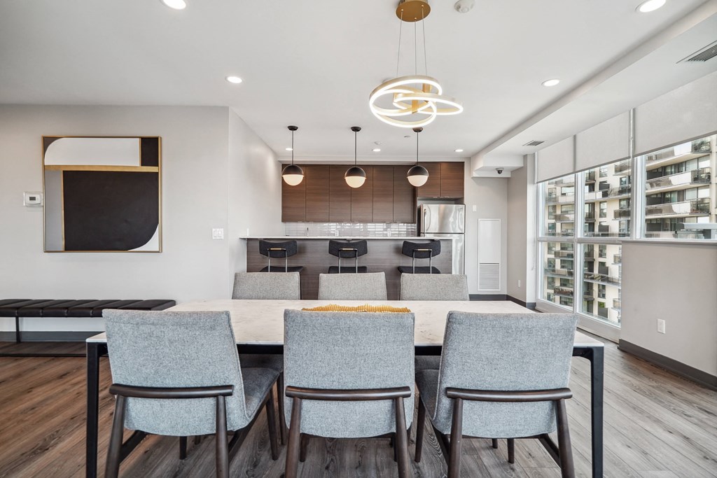 a kitchen and dining room with a large table and chairs