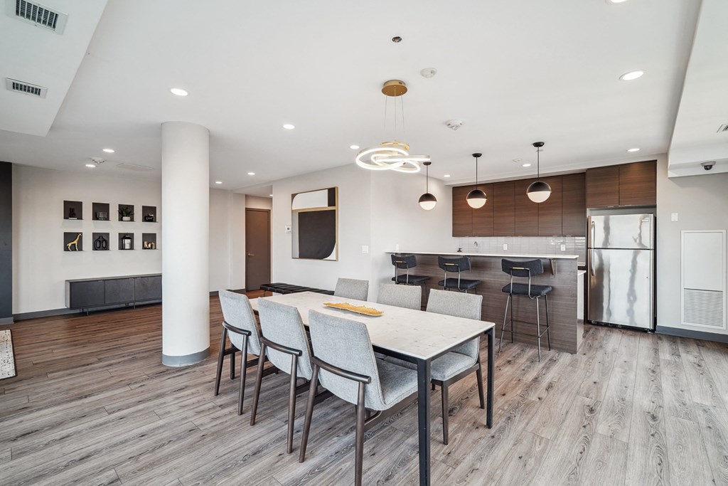 a kitchen and dining room with a white table and chairs
