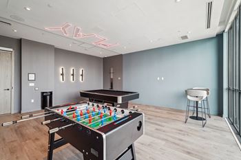 a game room with a foosball table and a pool table