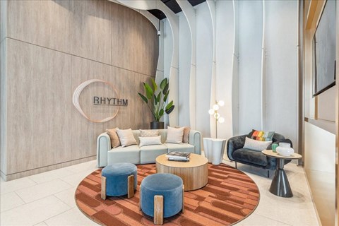 A modern living room with a wooden floor and a large sofa.