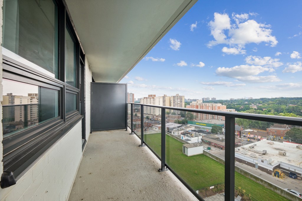 a balcony with a view of a city and a clear blue sky