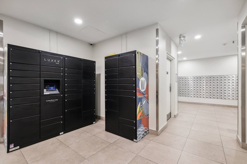 a utility room with black lockers and a vending machine