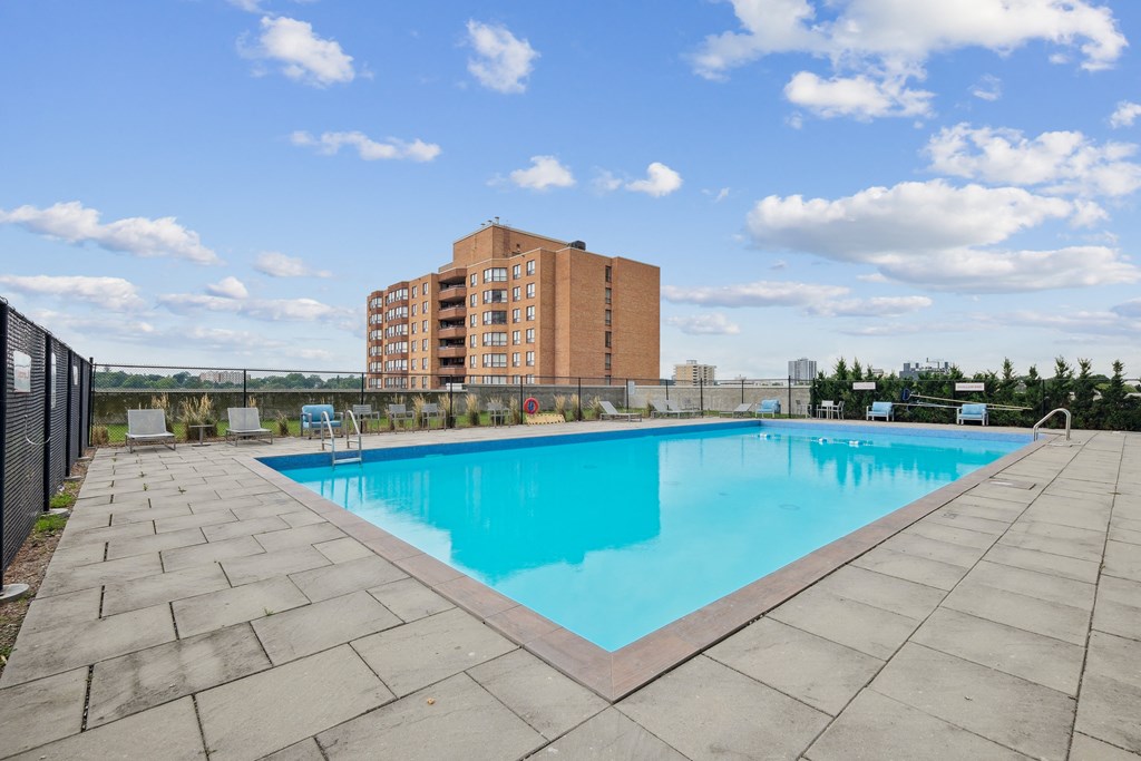 a swimming pool with a building in the background