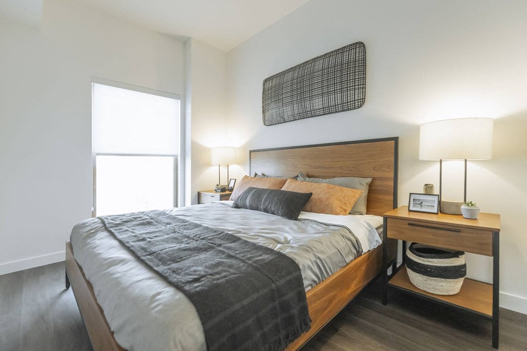 a bedroom with a bed and a window