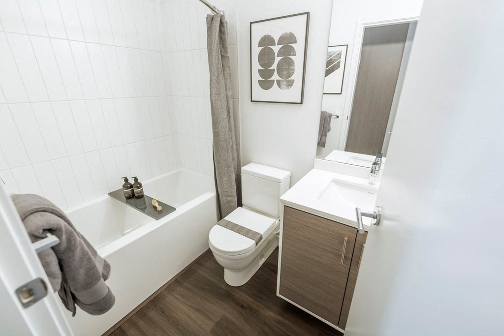 a small bathroom with a toilet sink and tub