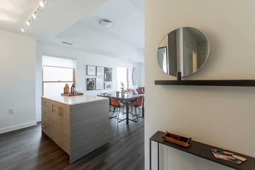 a kitchen and dining room with a mirror on the wall