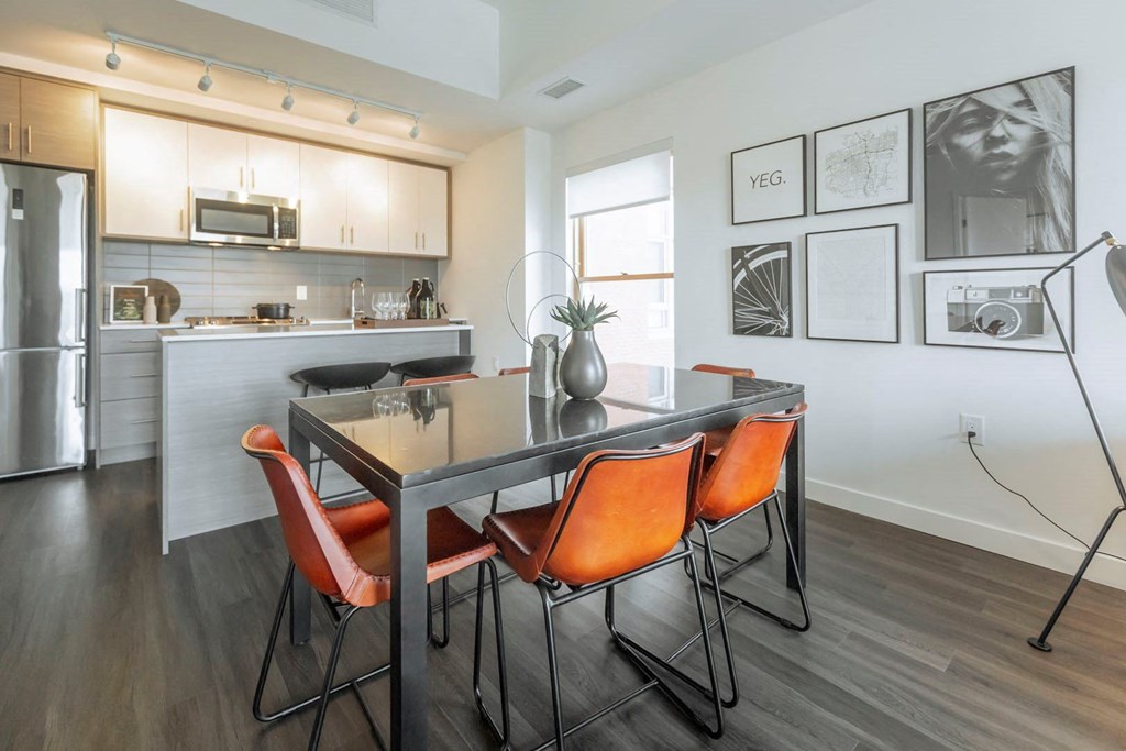 a kitchen and dining room with a table and chairs