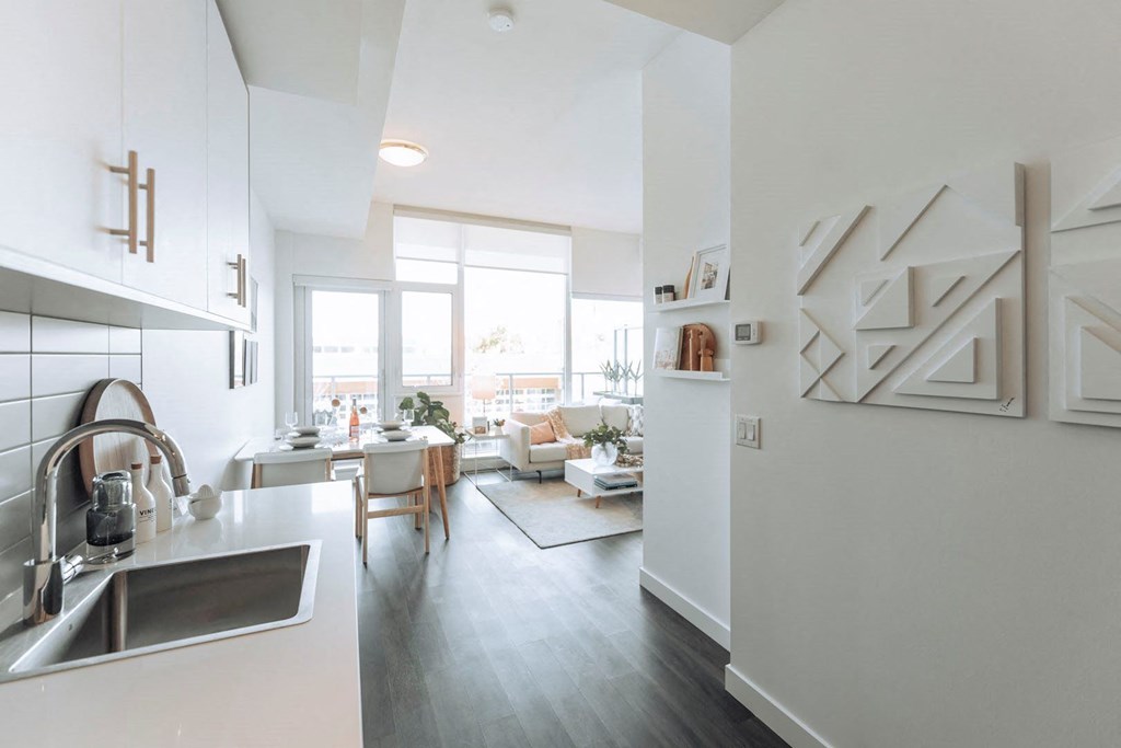 a view of a living room and kitchen from a kitchen counter