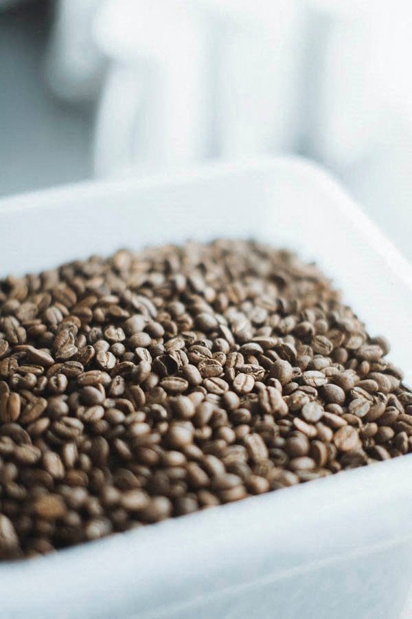 a bowl of coffee beans on a table