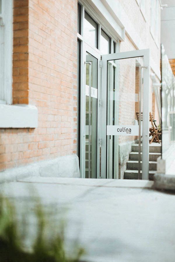 the entrance to a building with stairs and a glass door