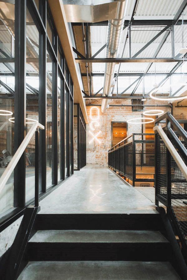 the lobby of a building with a glass ceiling and stairs