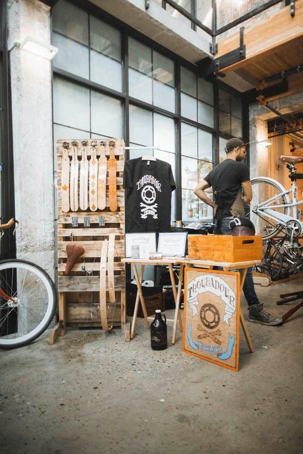 a man is working in a bike shop with a table