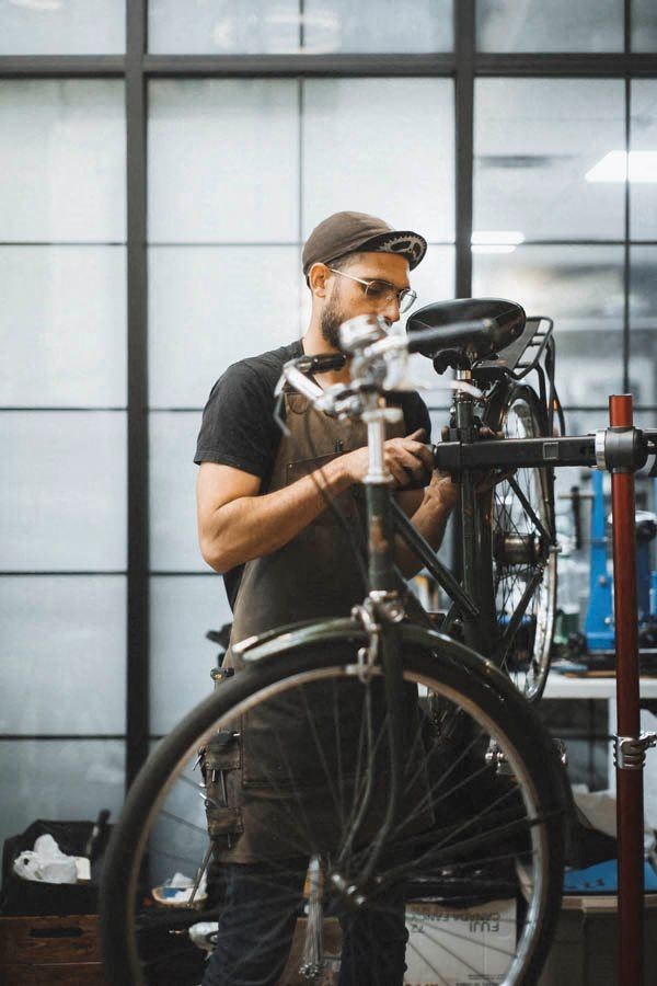 a man working on a bike in a garage