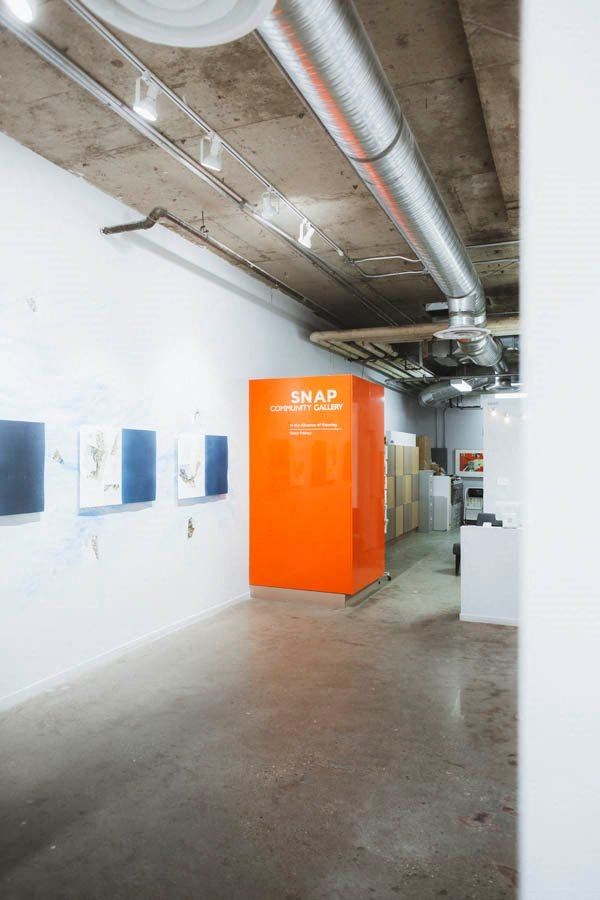 a large room with an orange door in the middle of it