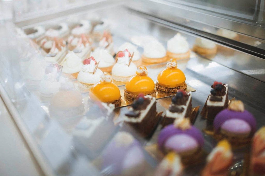 a display case filled with lots of different types of cupcakes