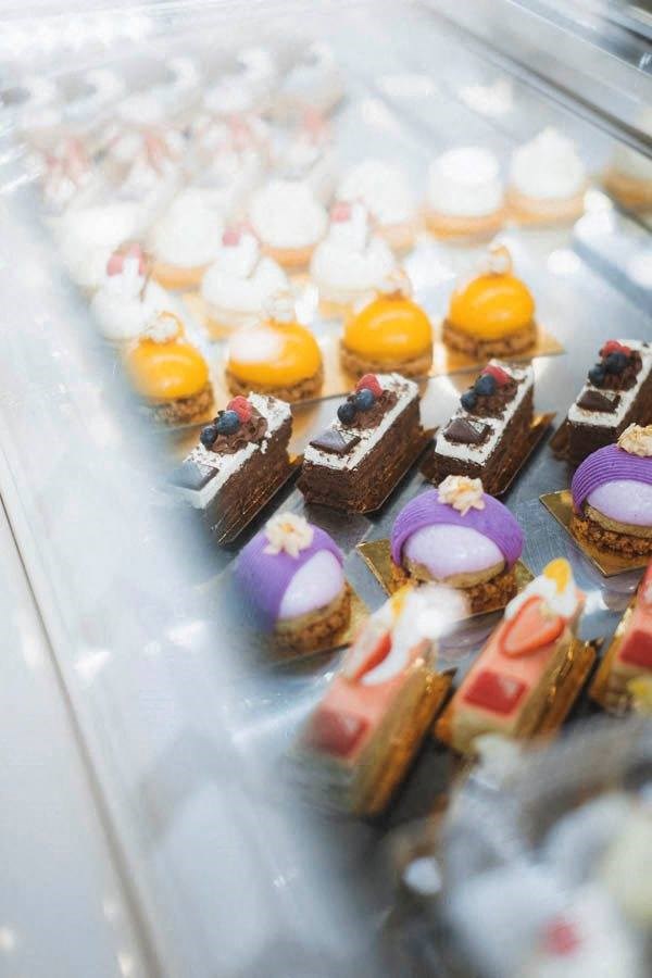 a display of pastries and cakes in a display case