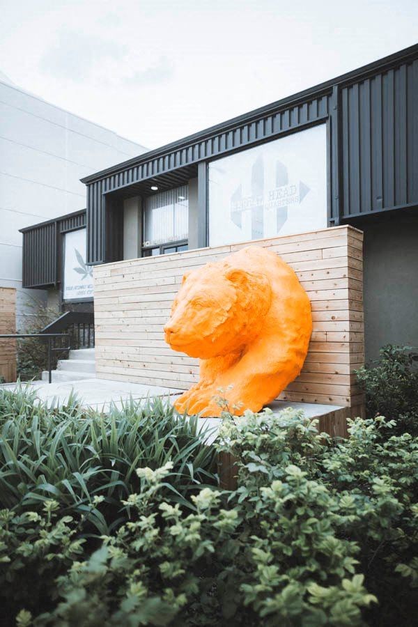 a large orange stuffed animal in front of a house