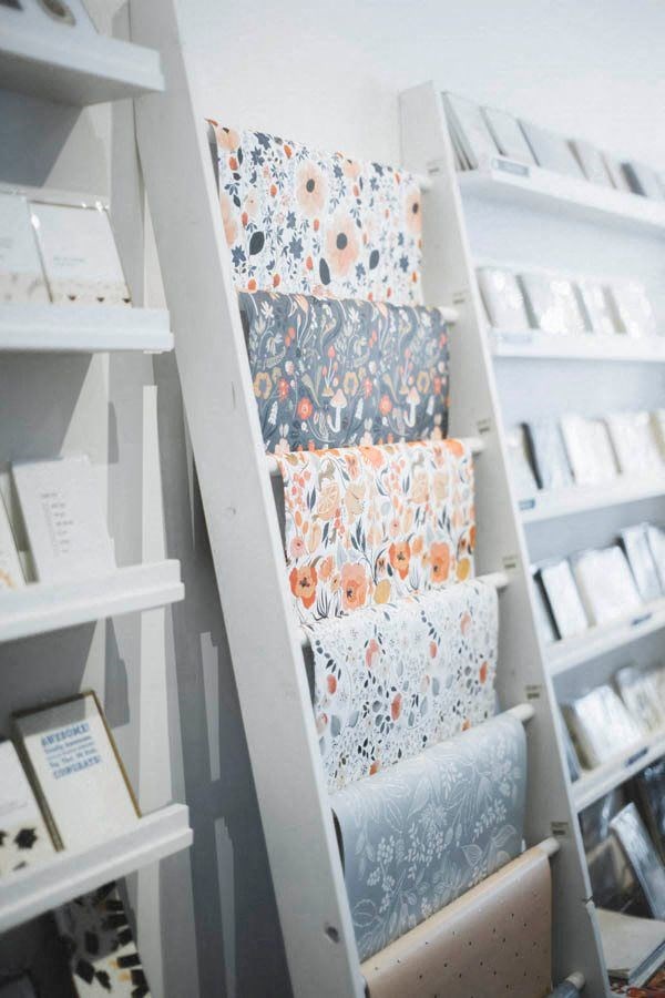 a stack of rolls of toilet paper on a shelf in a closet