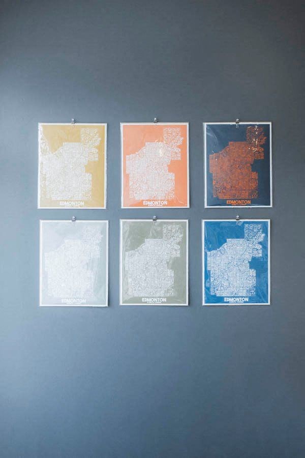 four maps hanging on a wall