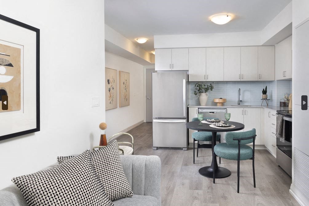 a living room with a couch and a table and a refrigerator