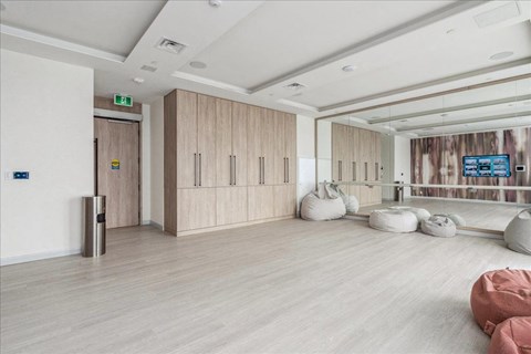 A room with wooden floors and a wall mural with a forest scene.