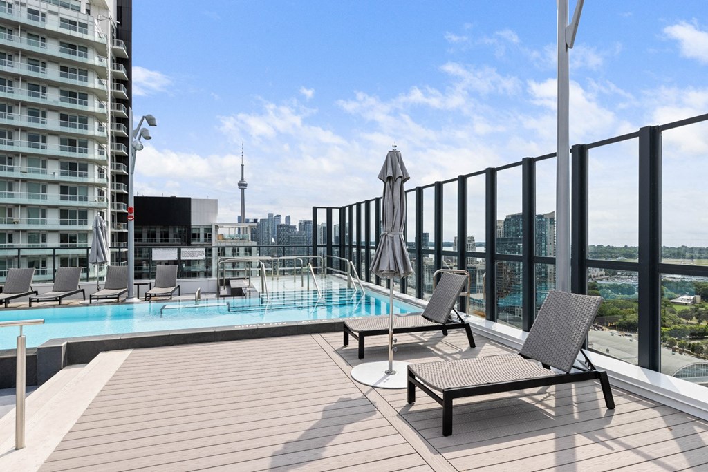 a pool on a balcony with a view of the city