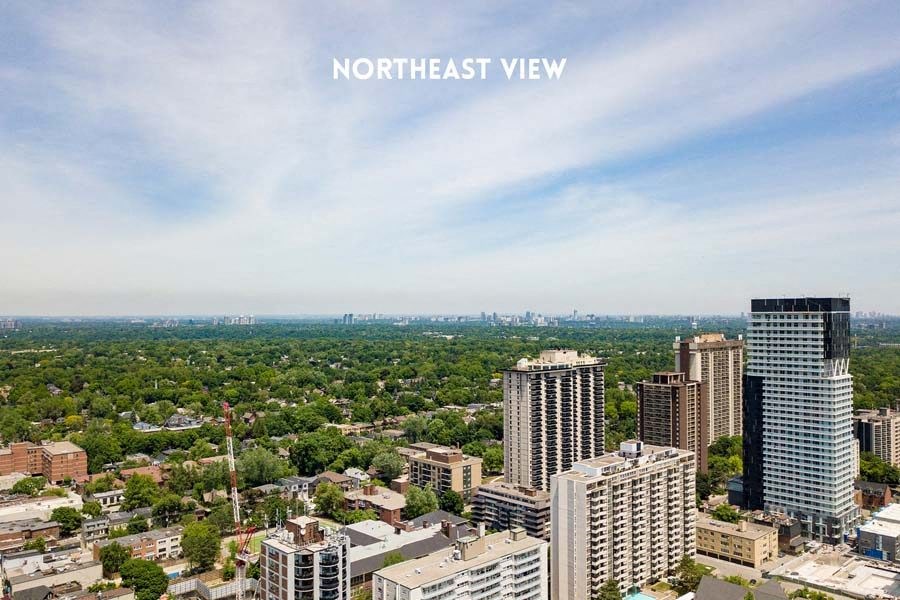 an aerial view of a city with tall buildings and trees