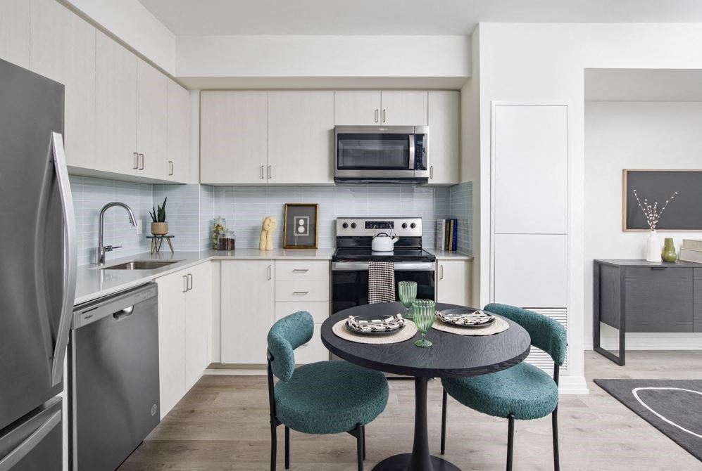 a kitchen and dining room with a table and chairs