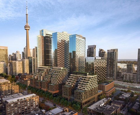 A cityscape with a variety of buildings, including a tall tower in the background.