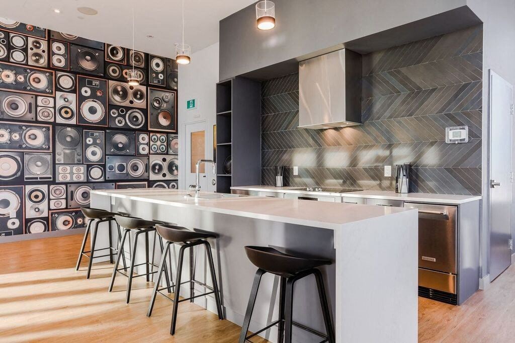a kitchen with a counter and bar stools