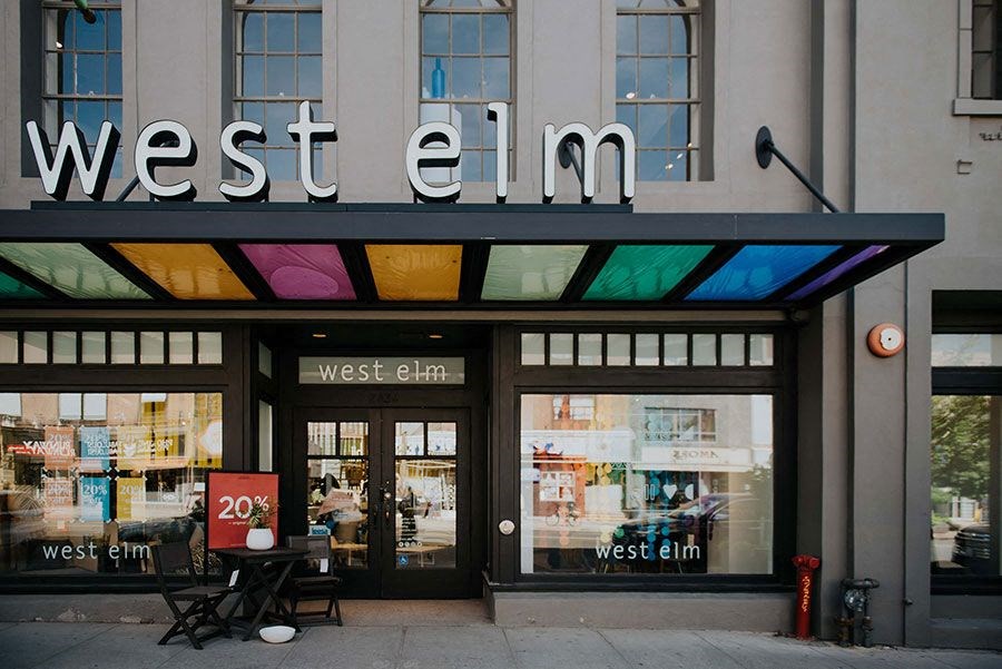a building with a west elm sign on the front of it