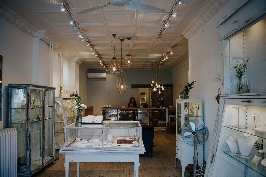 a store with glass cases and lights on the ceiling