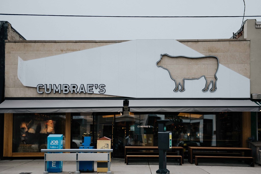 a building with a sign of a cow on the side of it