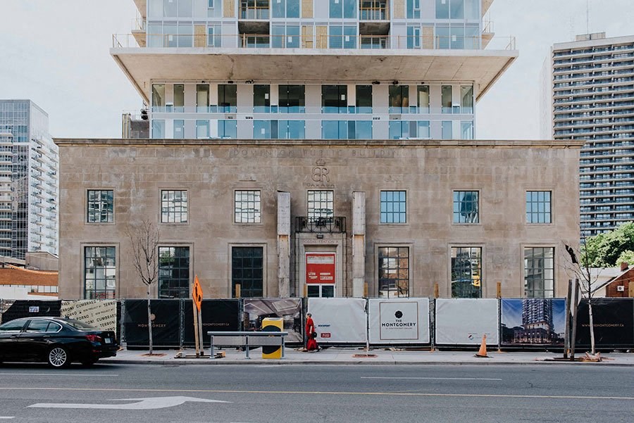 a building on the side of a street with a car