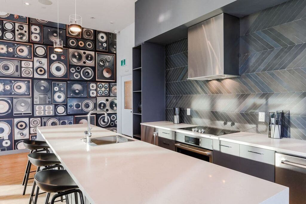 a kitchen with a white counter top and a sink
