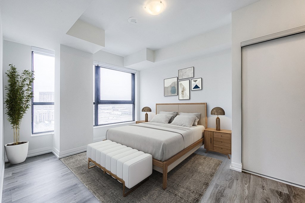 an apartment bedroom with a bed and a window