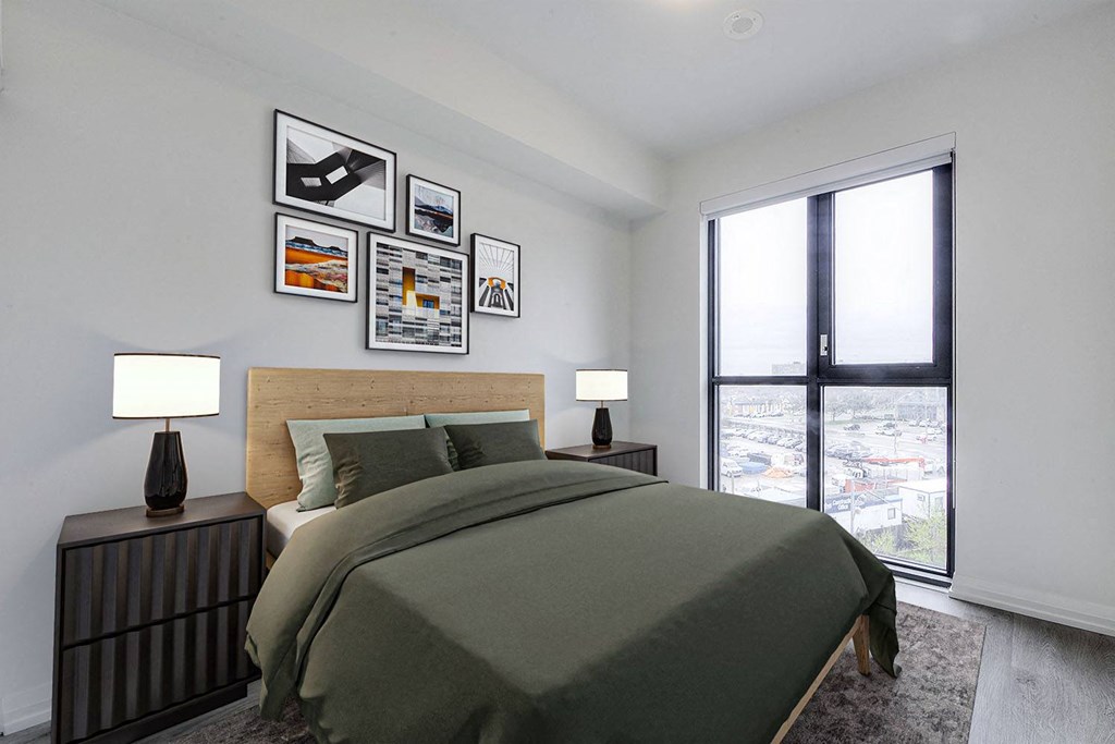 a bedroom with a bed and a large window