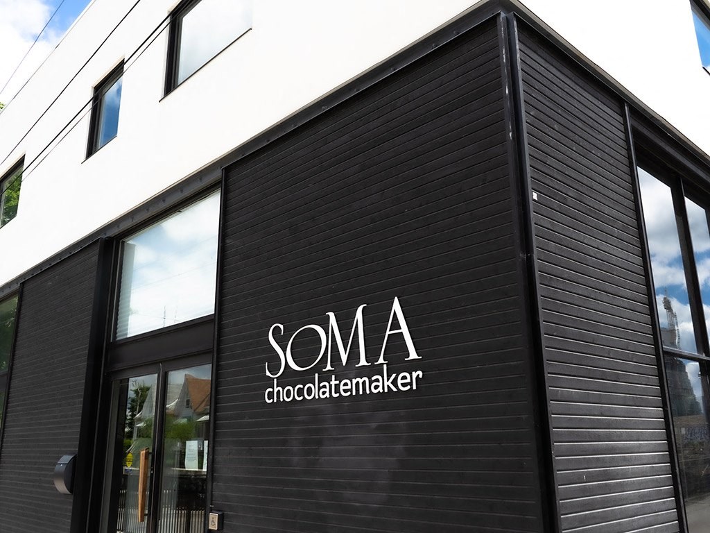 a logo on the side of a black building