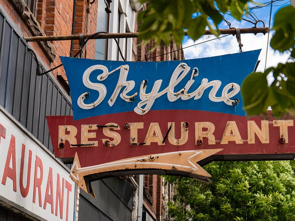 a sign for a restaurant on the side of a building