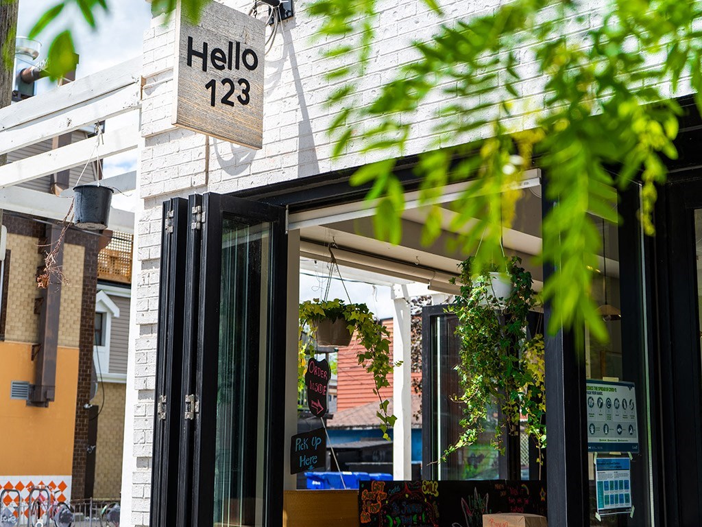 the front of a restaurant with a sign that reads hello 123