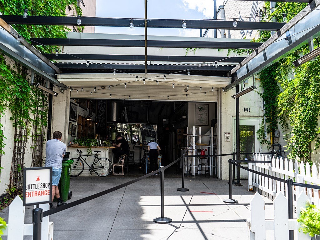 the entrance to a restaurant with people walking into the building