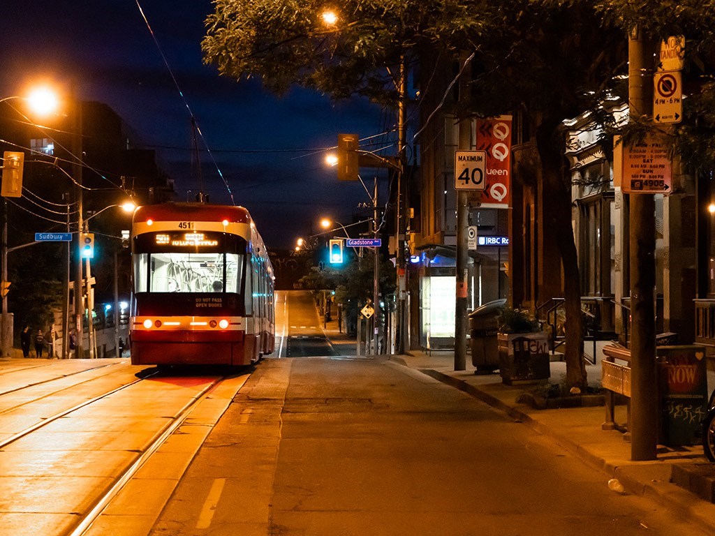 a city bus driving down a city street at night