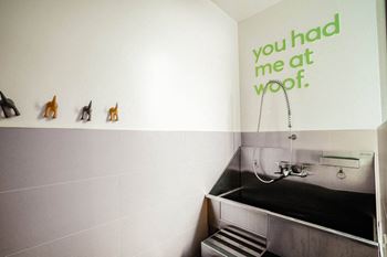 a bathroom with a sink and a quote on the wall